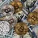 popular cryptocurrency bitcoin placed on top of the USD bill