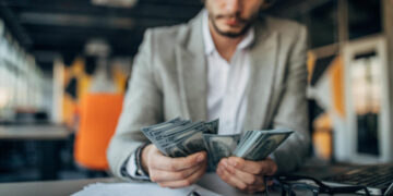 Disciplined trading mindset, technical analysis gold prices. Man counting the money, Math in forex.